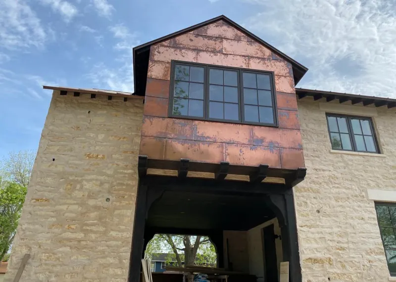 Copper metal panel facade on a stone building for Skylight Installation in Sterling Heights