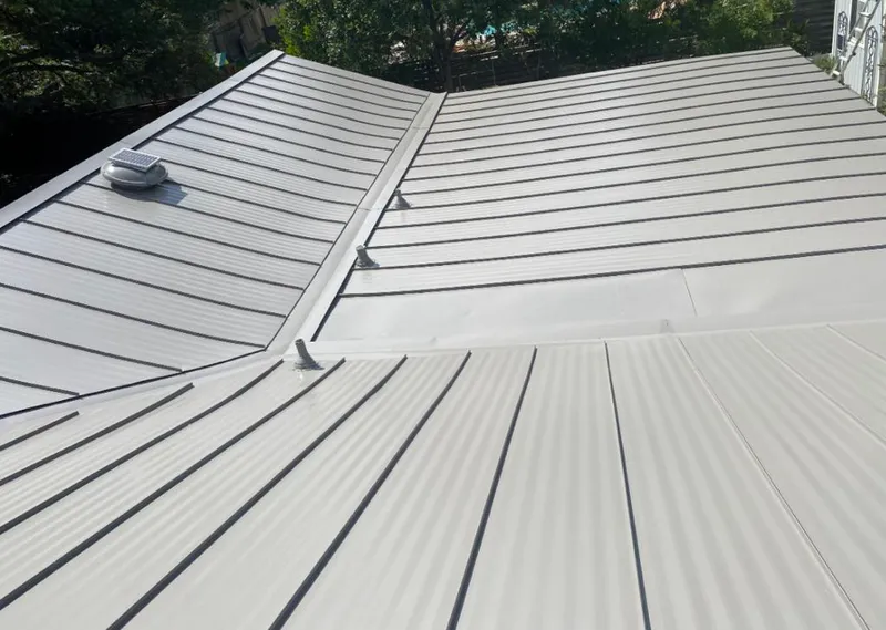 Solar attic fan installed on a metal roof for Roof Ventilation in Sterling Heights